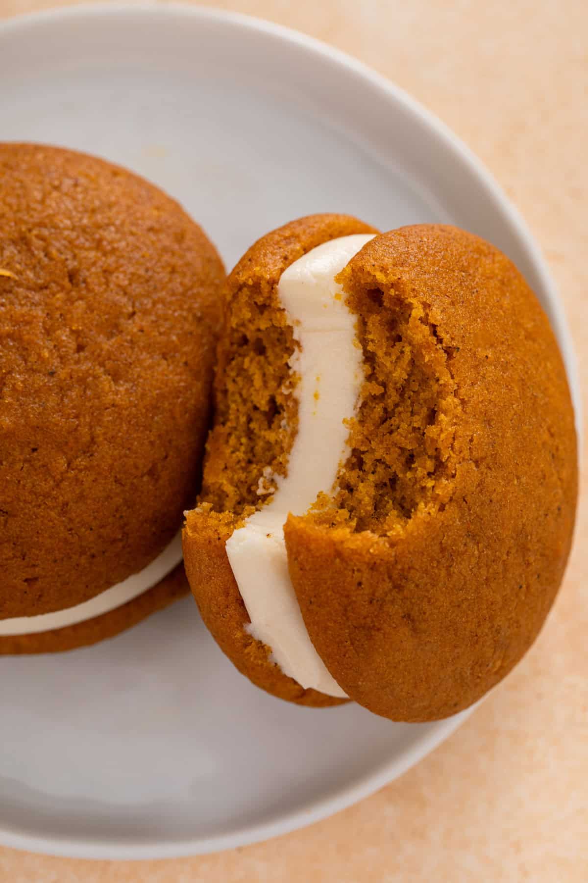 Close up of a bite taken from a pumpkin whoopie pie.
