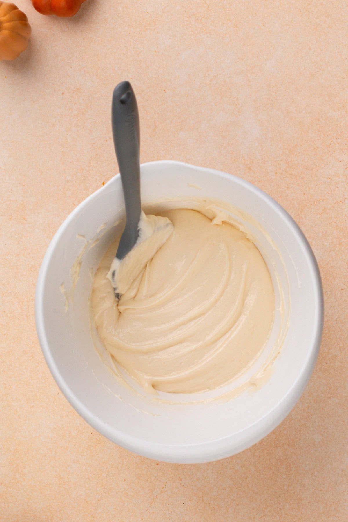Cream cheese filling for pumpkin whoopie pies mixed in a white bowl.