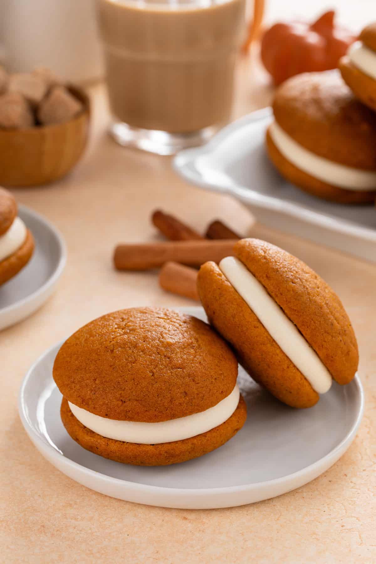 Two pumpkin whoopie pies arranged on a gray plate.