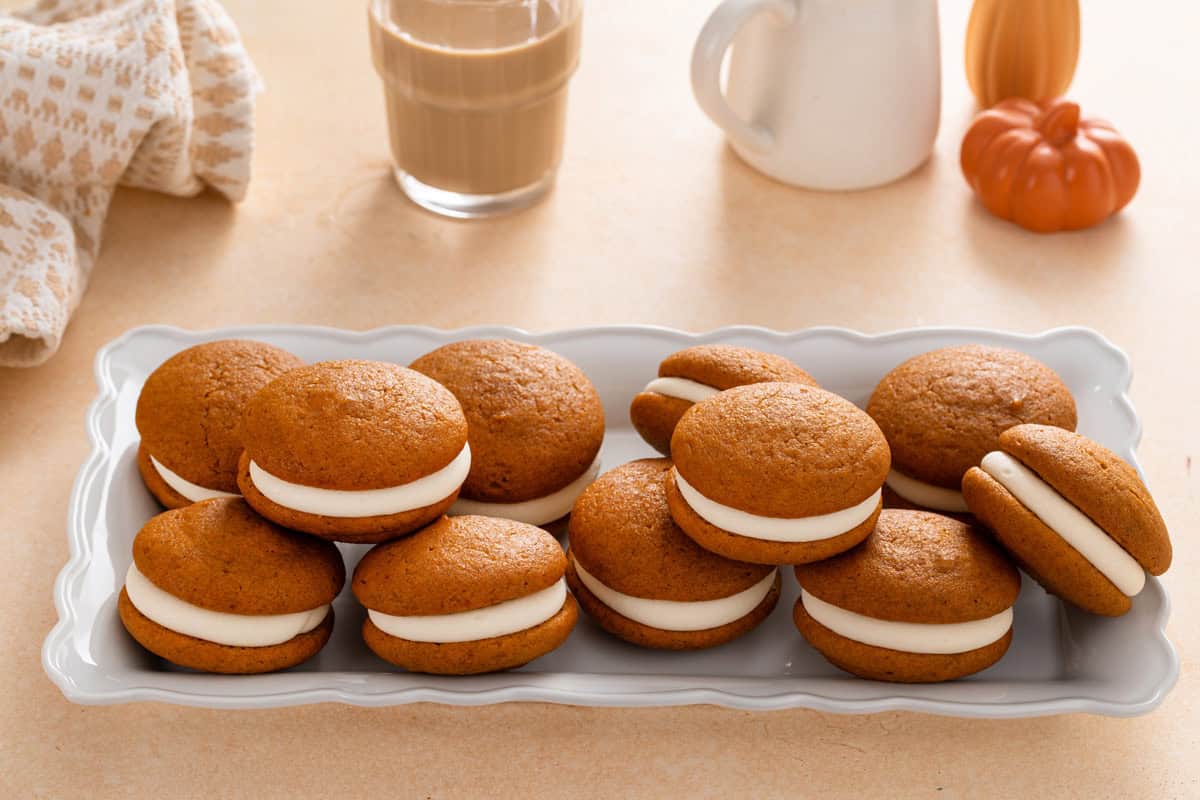 Pumpkin whoopie pies arranged on a long platter.
