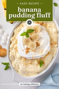 White serving dish filled with banana pudding fluff, garnished with whipped cream and sliced bananas. Text overlay includes recipe name.