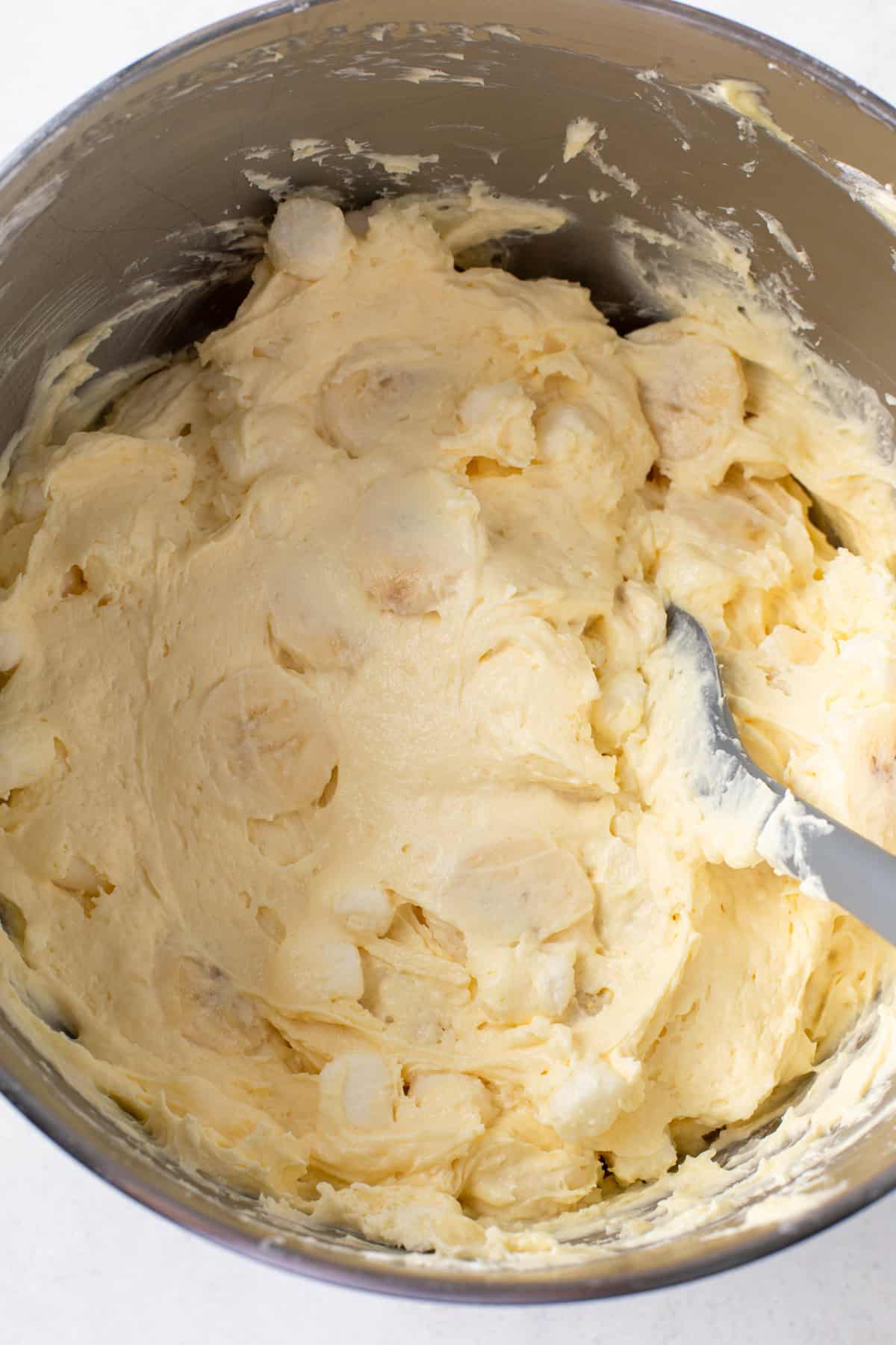 Sliced bananas folded into banana pudding fluff.