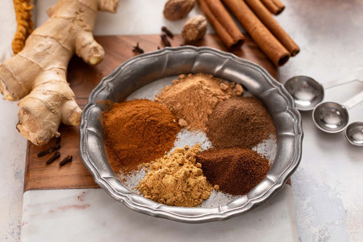Plate holding each of the spices for pumpkin pie spice.