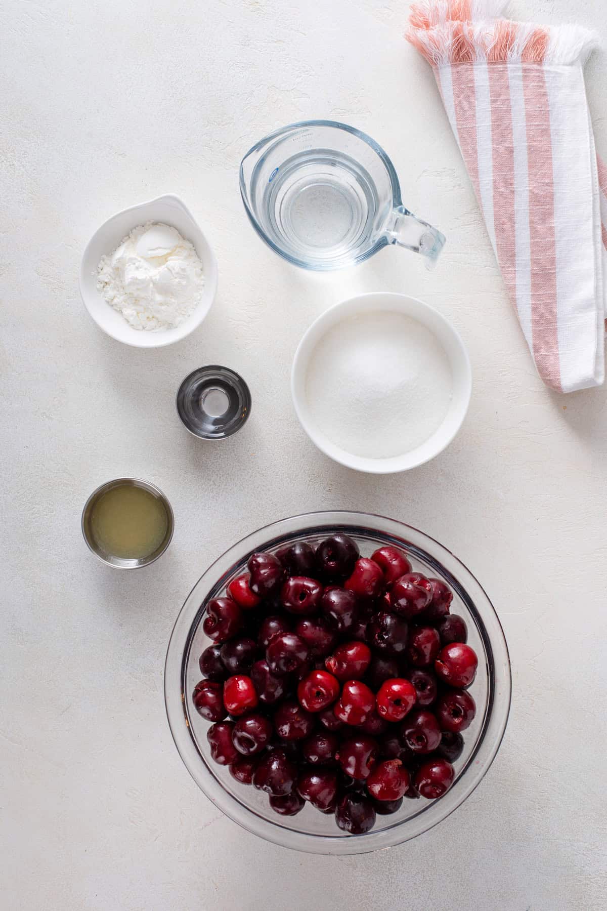 Cherry pie filling ingredients arranged on a countertop.