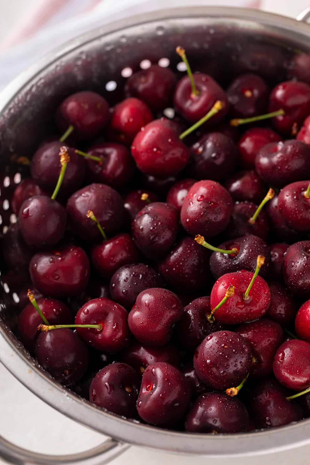 Fresh sweet cherries in a colander.