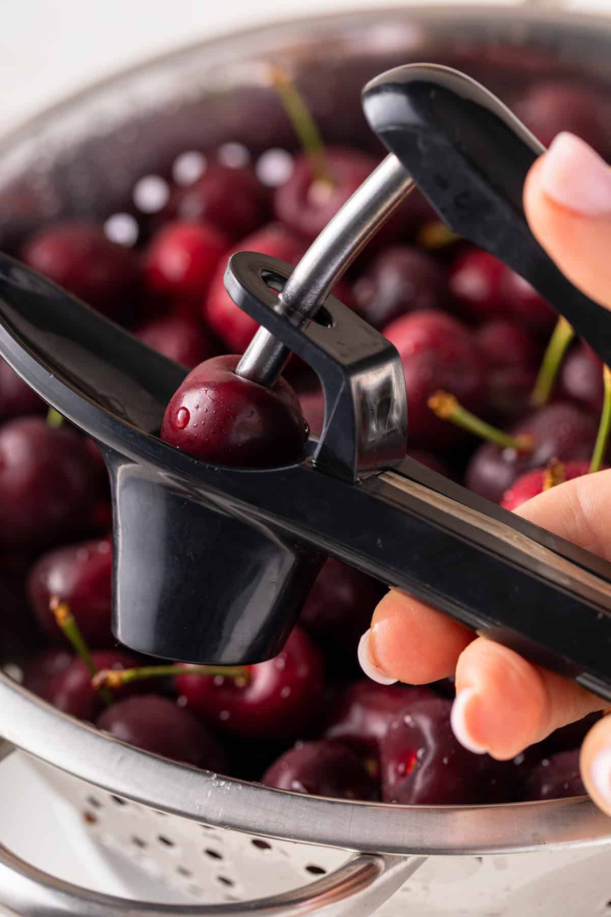 Fresh cherry being pitted.