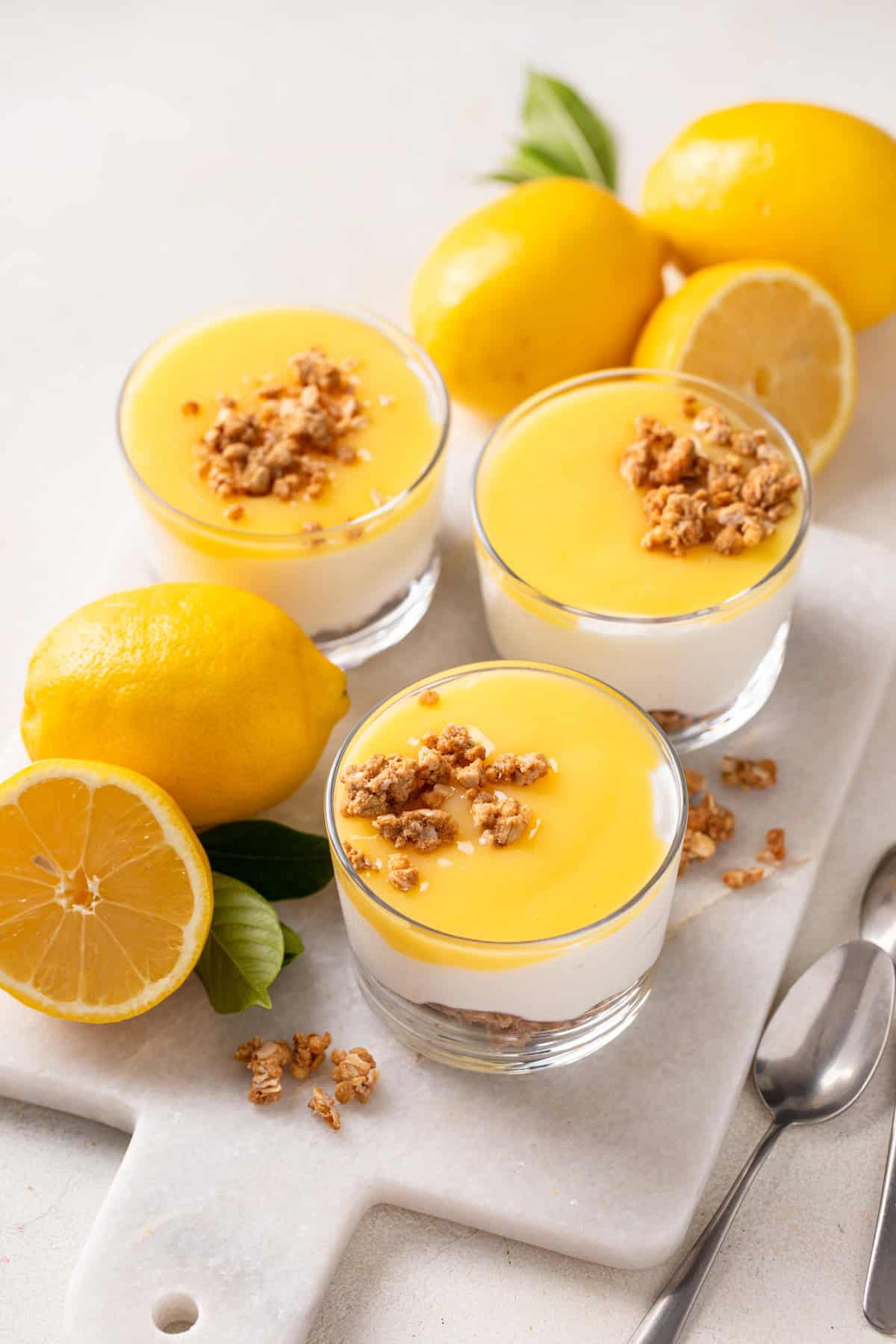 Three ramekins of cheesecake topped with microwave lemon curd.