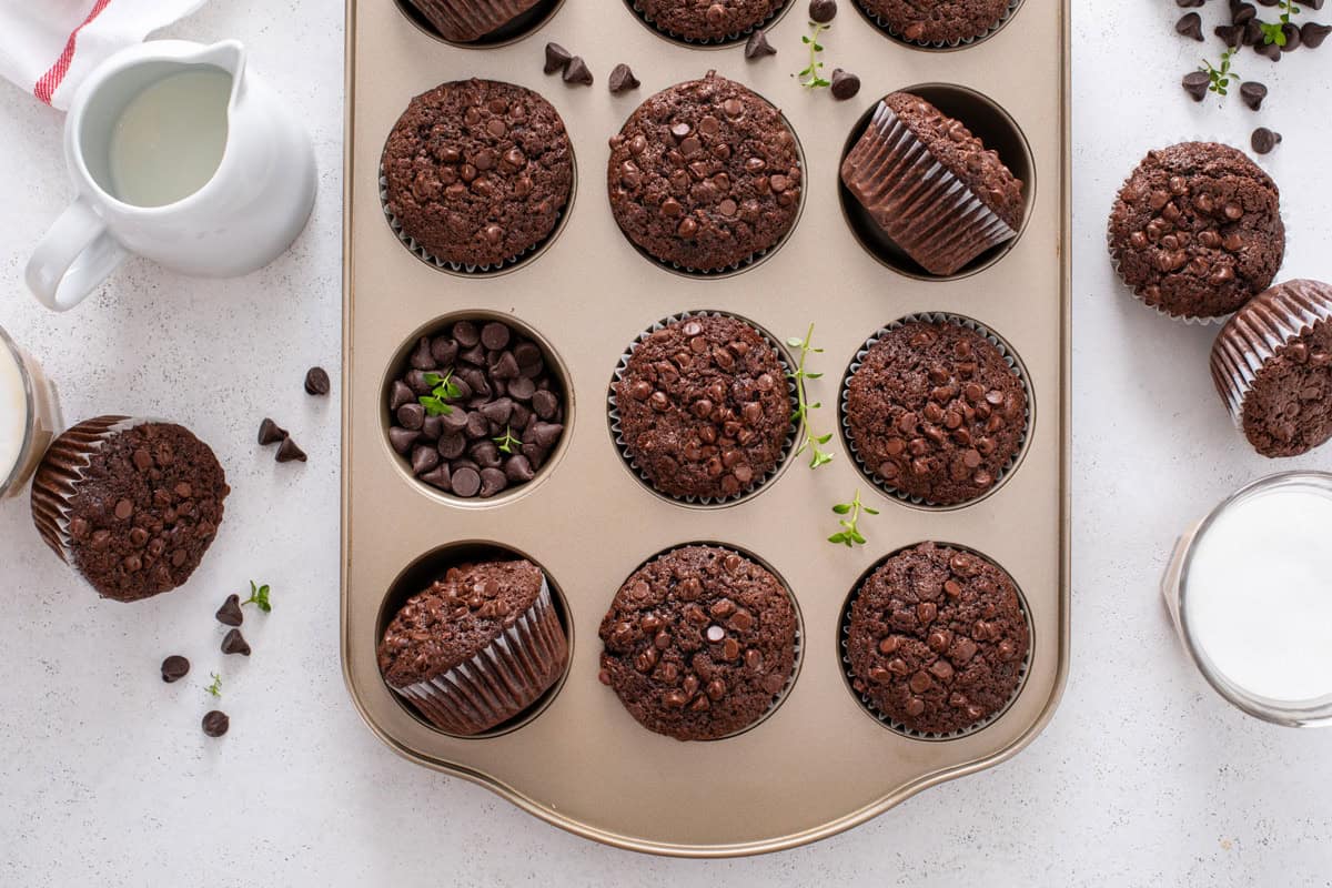 Cooled chocolate zucchini muffins arranged in a muffin tin.