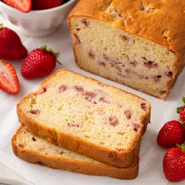 Slices of strawberry bread on a white board.