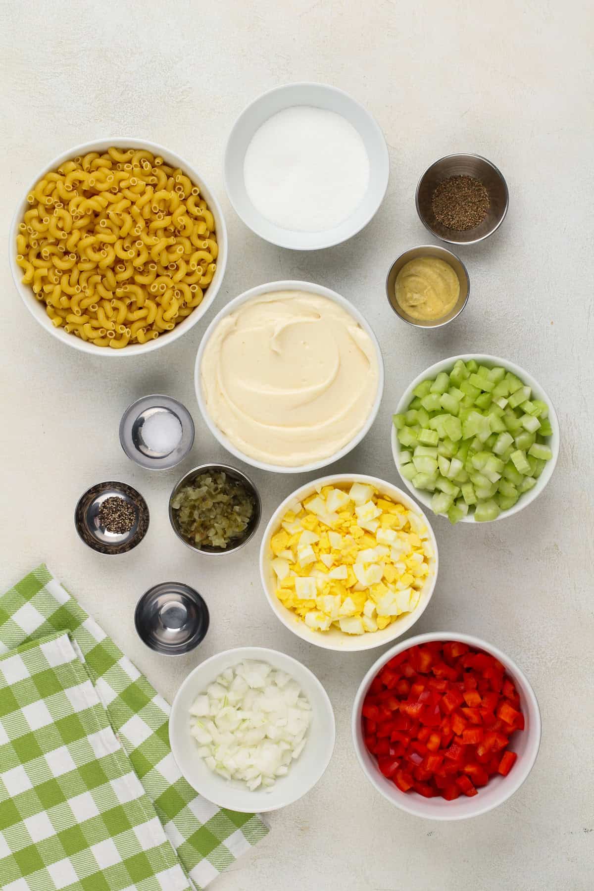 Amish macaroni salad ingredients arranged on a countertop.