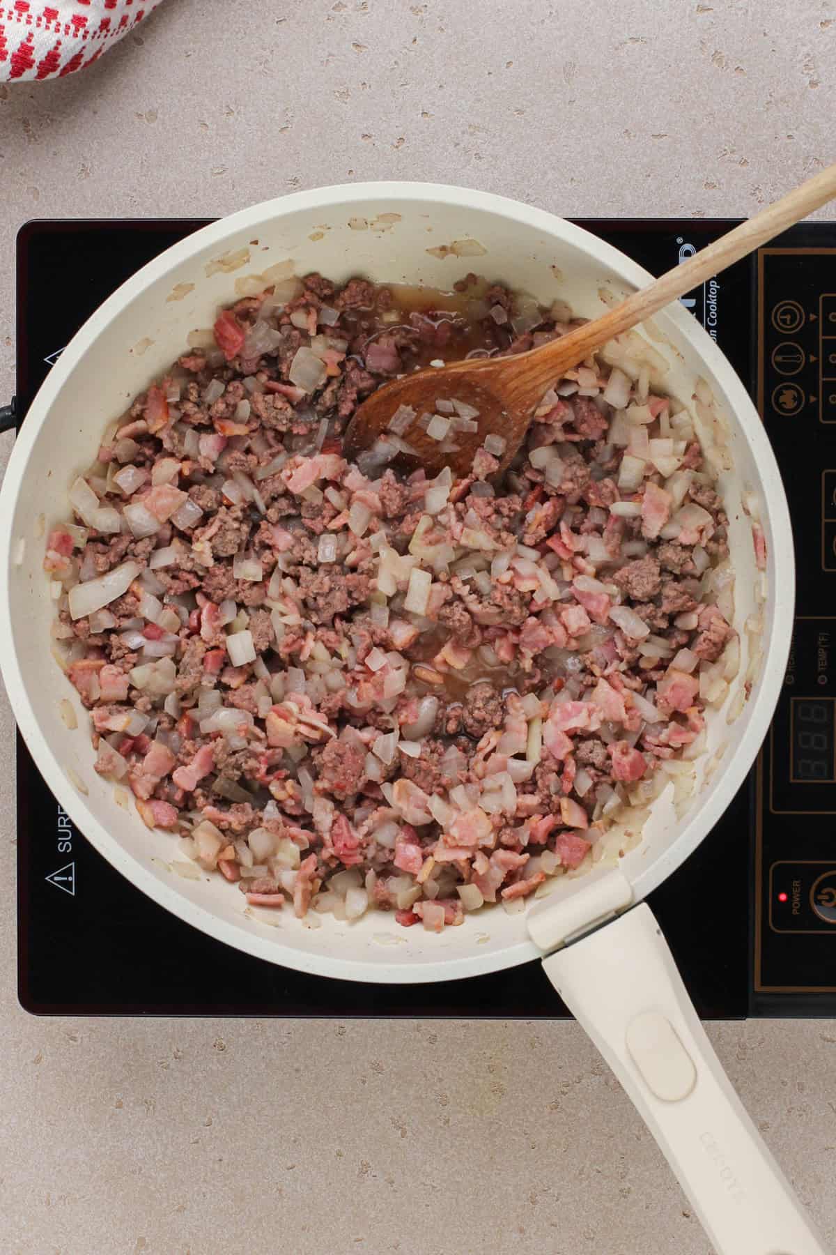 Browning meat and onions in a skillet.