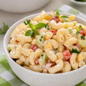 Close up of amish macaroni salad in a white bowl.
