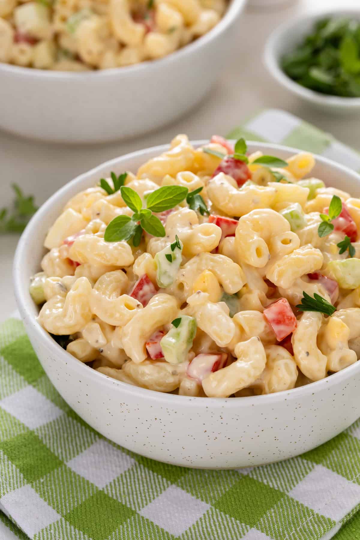Close up of a small white bowl holding a serving of amish macaroni salad.