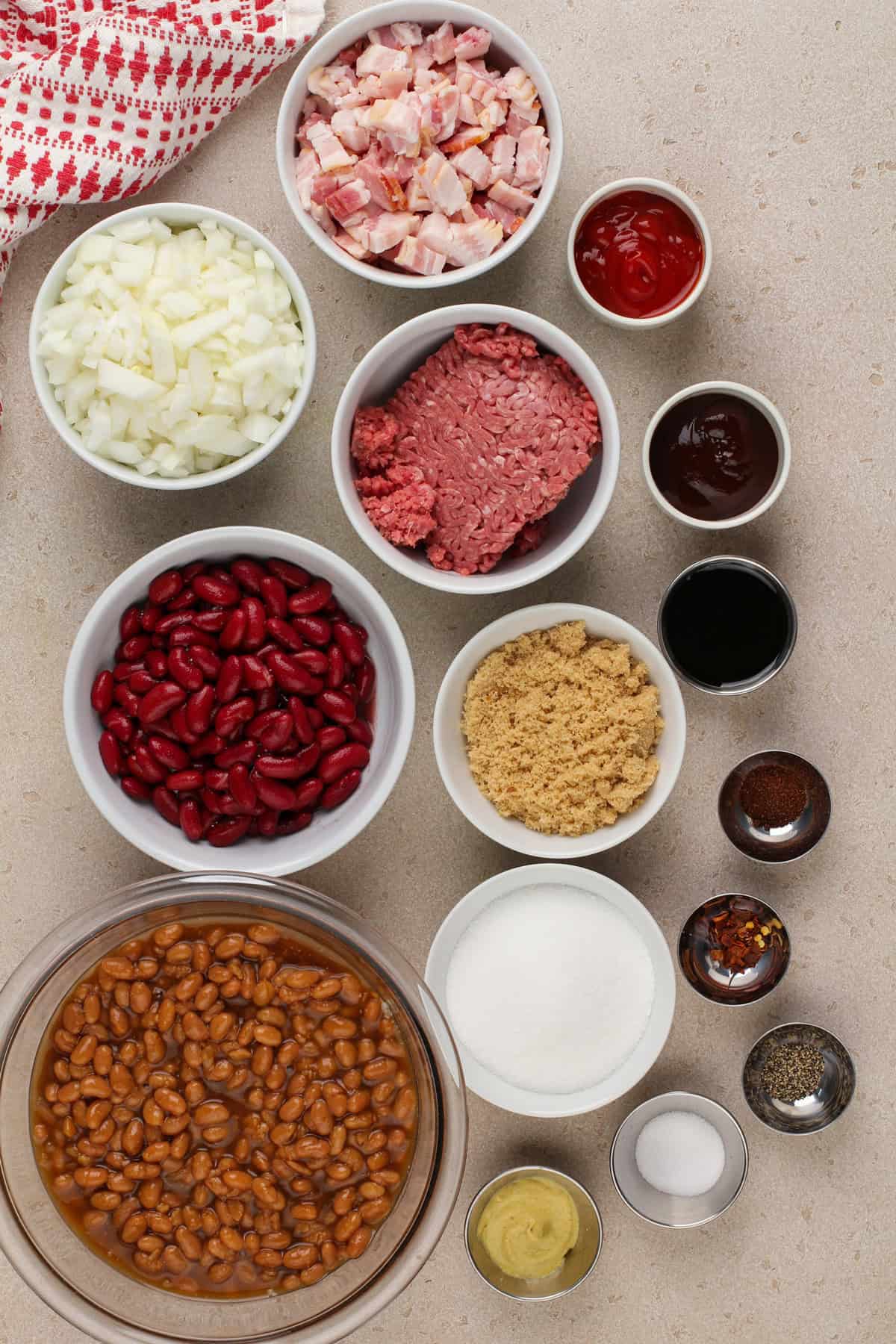 Easy baked bean ingredients arranged on a countertop.
