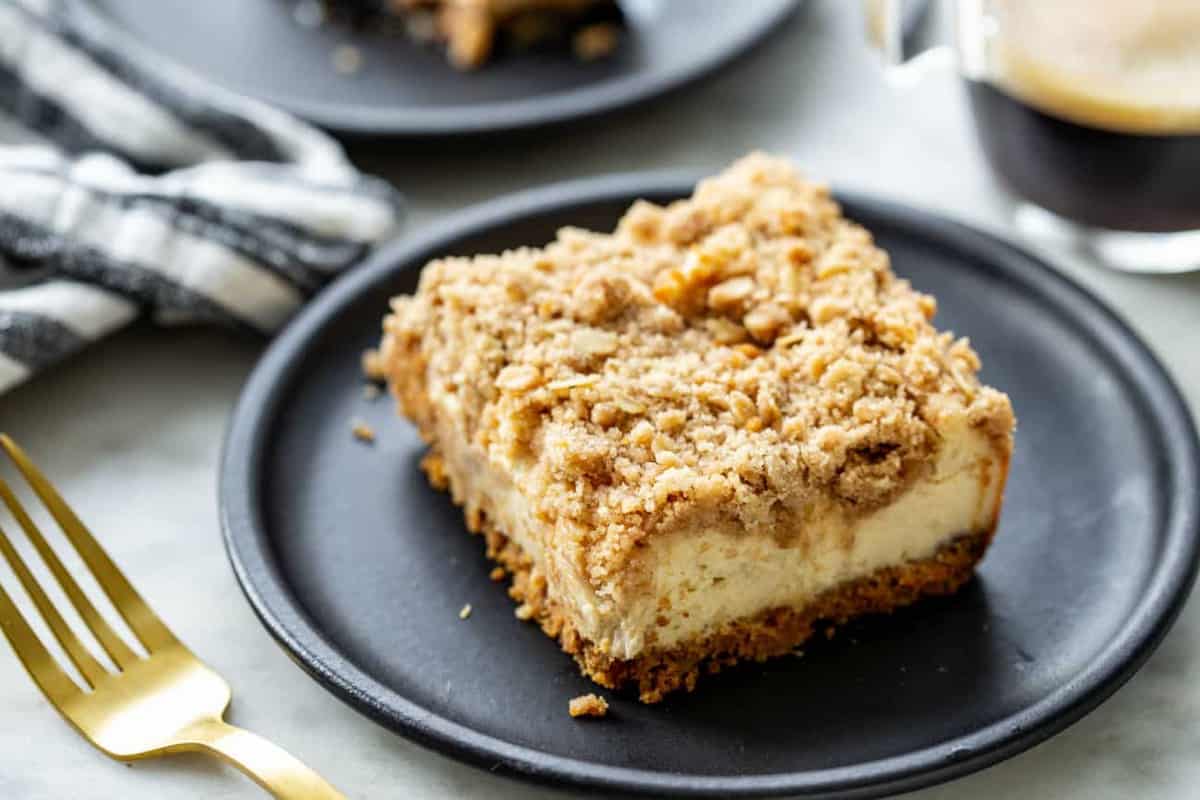 Slice of maple cheesecake bars on a black plate
