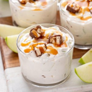 Small glass bowl filled with snickers apple salad.
