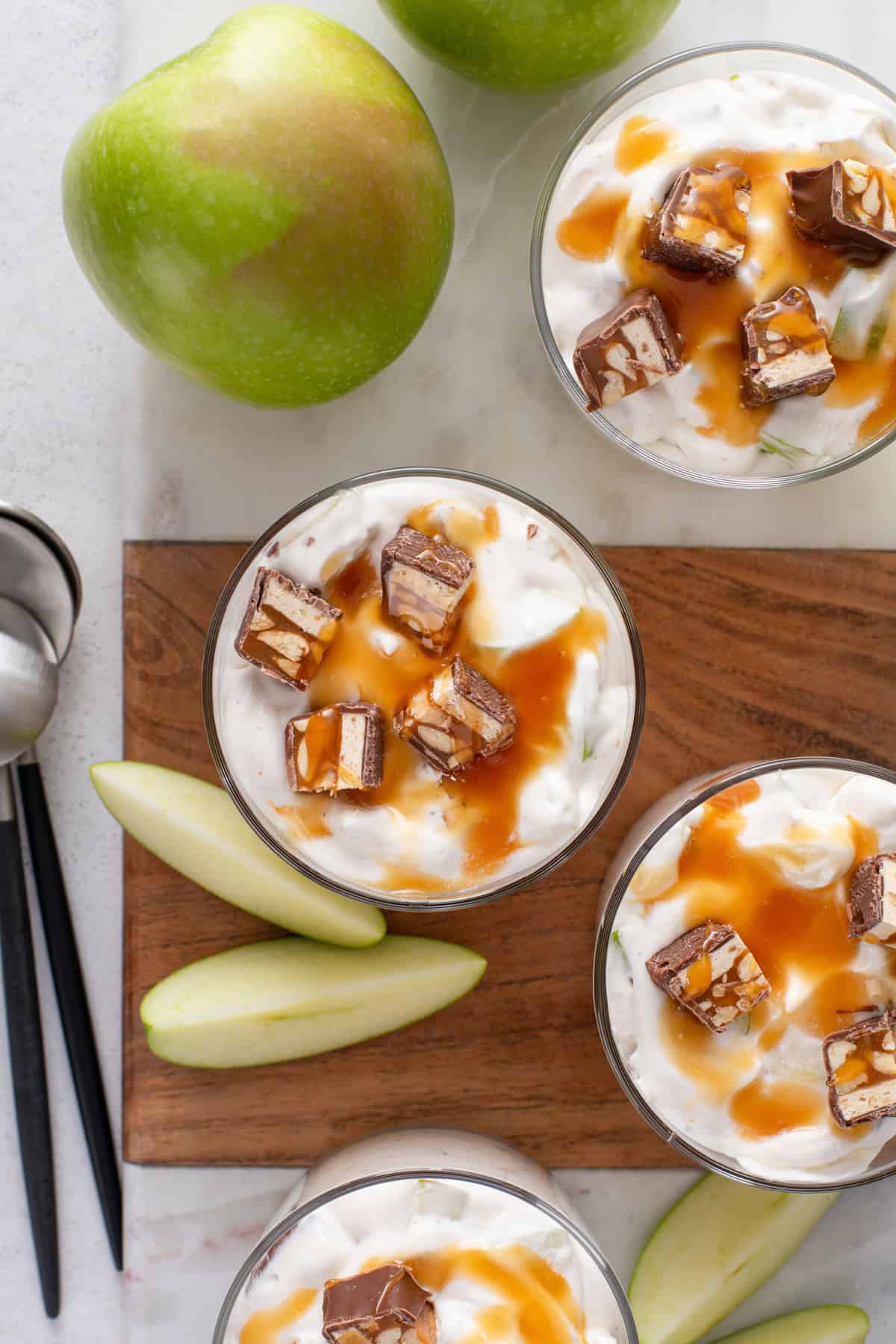 Overhead view of several small bowls of snickers caramel apple salad.