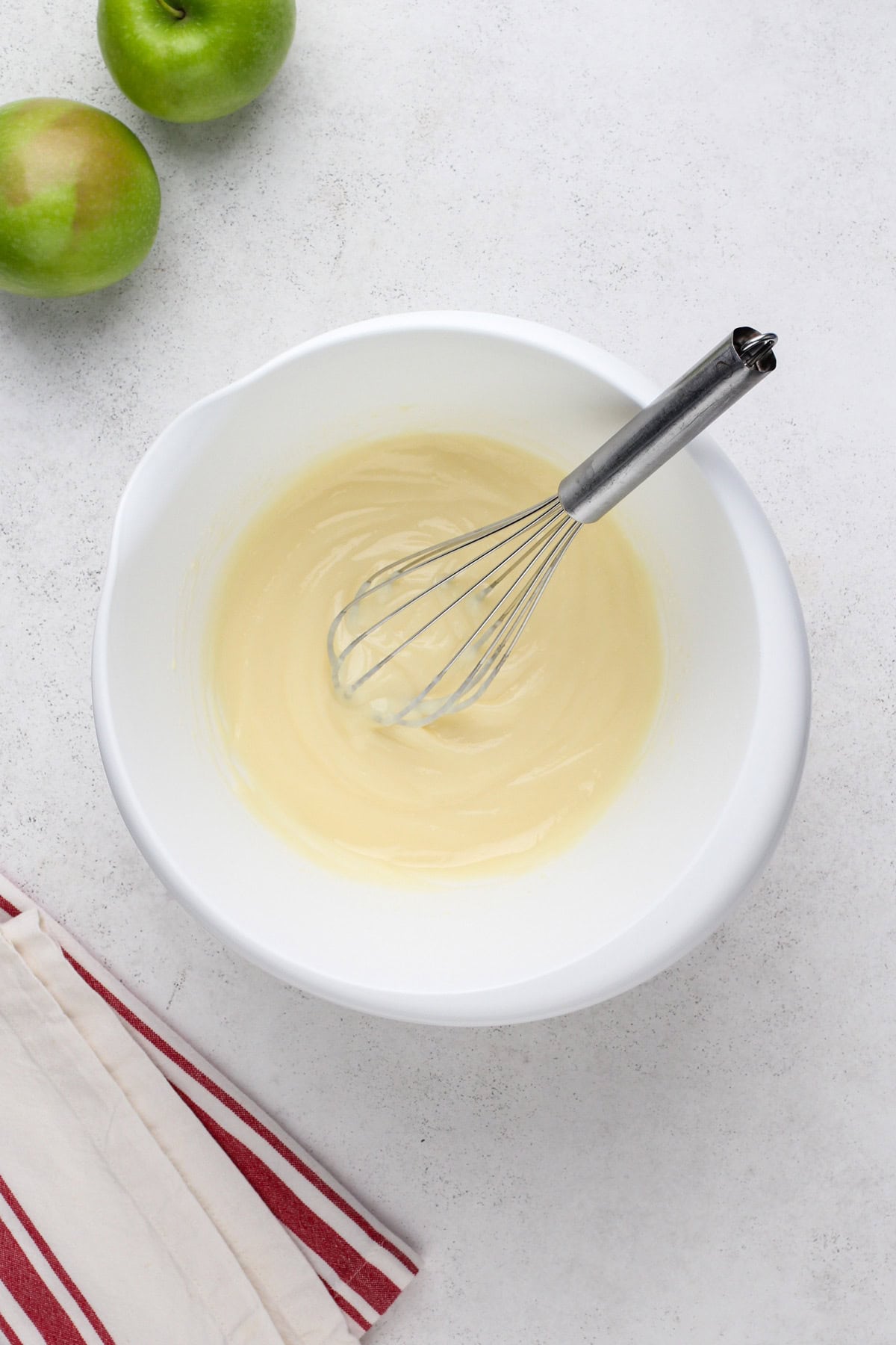 Cheesecake pudding mixed with milk in a white bowl.