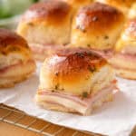 Close up of a hot ham and cheese slider.