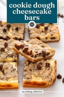 Close up of a cookie dough cheesecake bar leaning on other sliced bars on a white board. Text overlay includes recipe name.