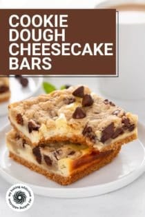 Two cookie dough cheesecake bars stacked on a white plate, with a bite taken from the corner of the top bar. Text overlay includes recipe name.