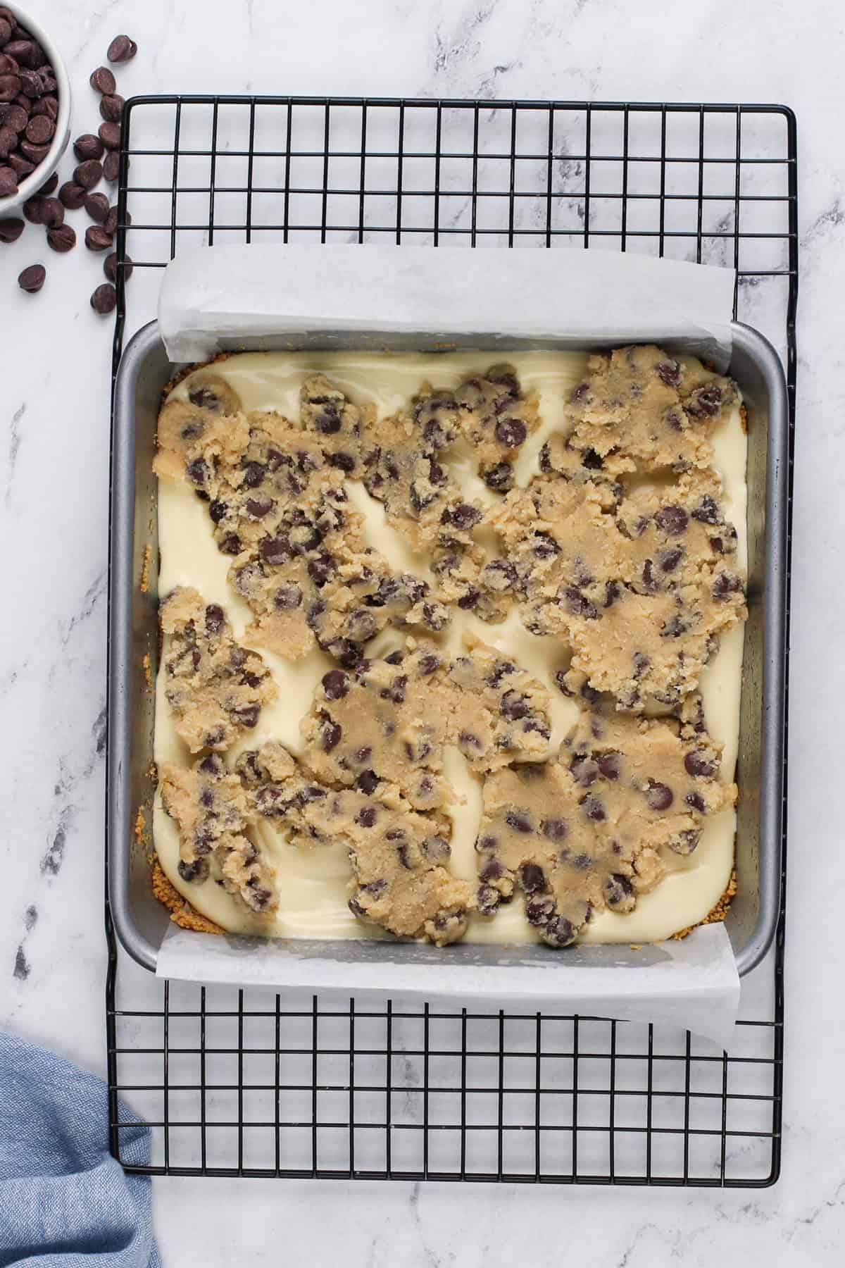 Assembled cookie dough cheesecake bars, ready to go in the oven.