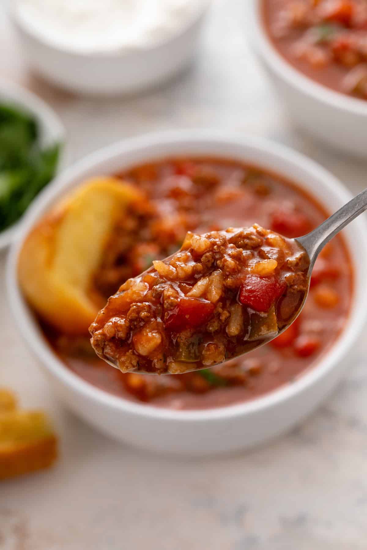 Spoon holding up a bite of stuffed pepper soup.