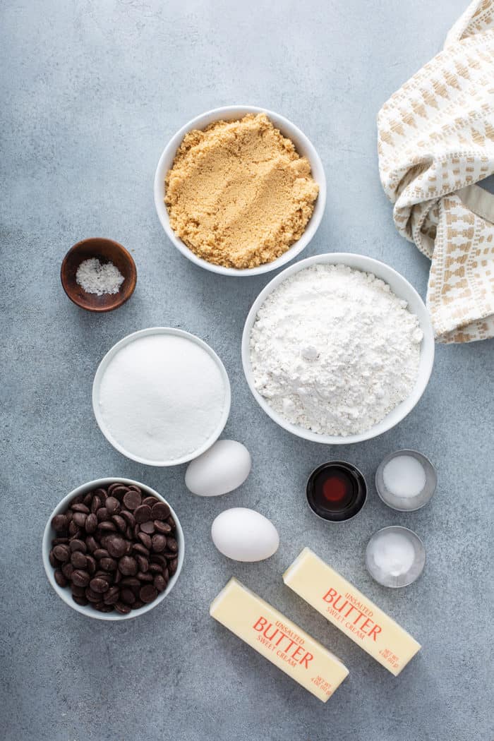 Ingredients for brown butter chocolate chip cookies arranged on a gray countertop