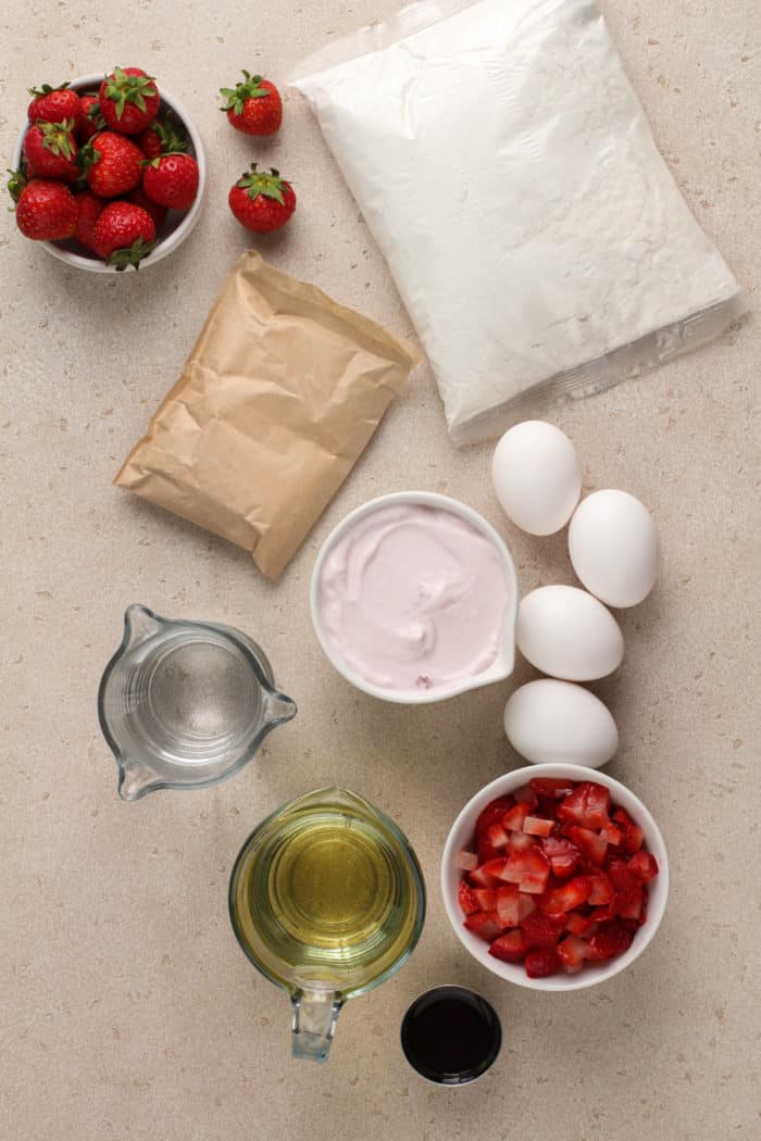 Strawberry layer cake ingredients arranged on a countertop.