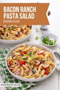 Two white bowls filled with bacon ranch pasta salad, set on a white countertop with a green and white napkin. Text overlay includes recipe name.