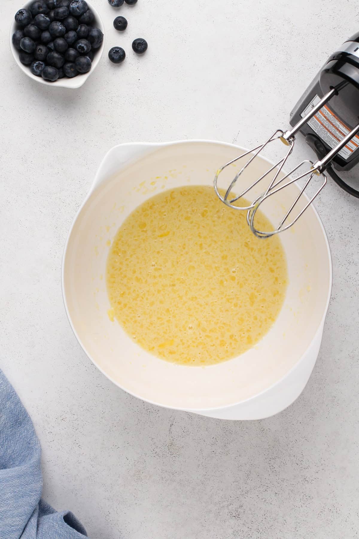 Wet ingredients for bisquick muffins in a white bowl.