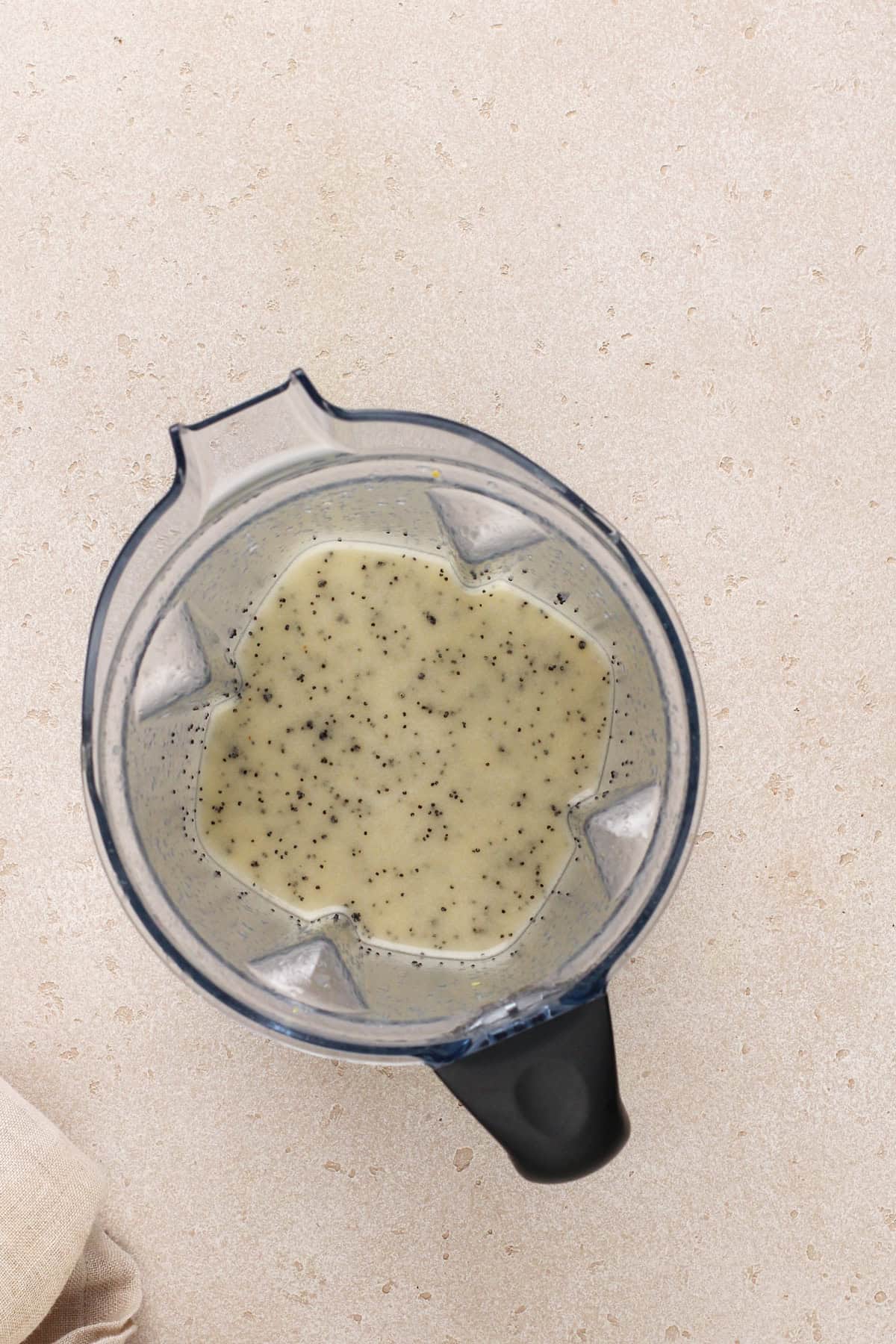 Blended poppy seed dressing in the bowl of a blender.