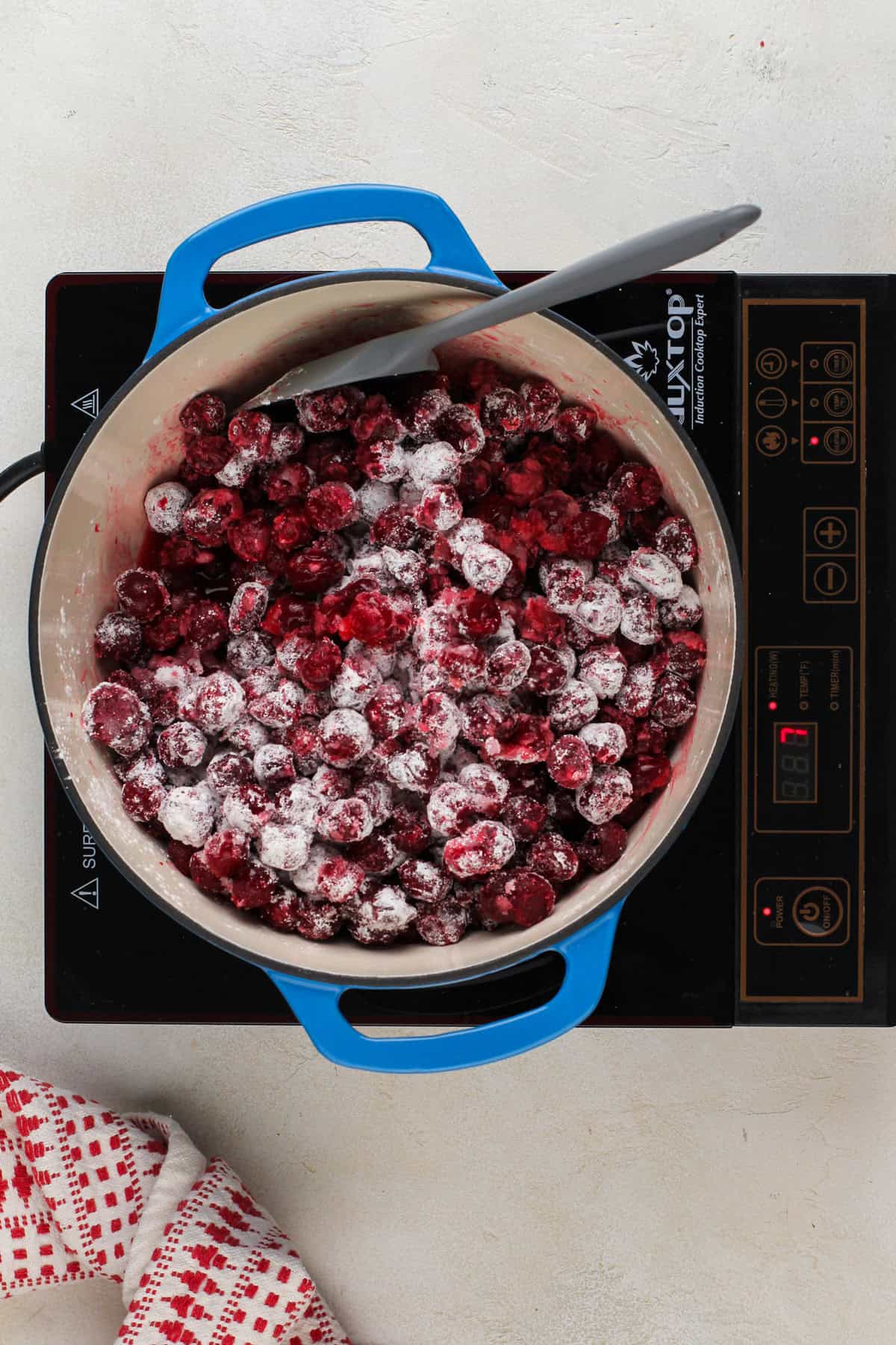 Ingredients for sour cherry pie filling in a dutch oven, ready to be cooked.