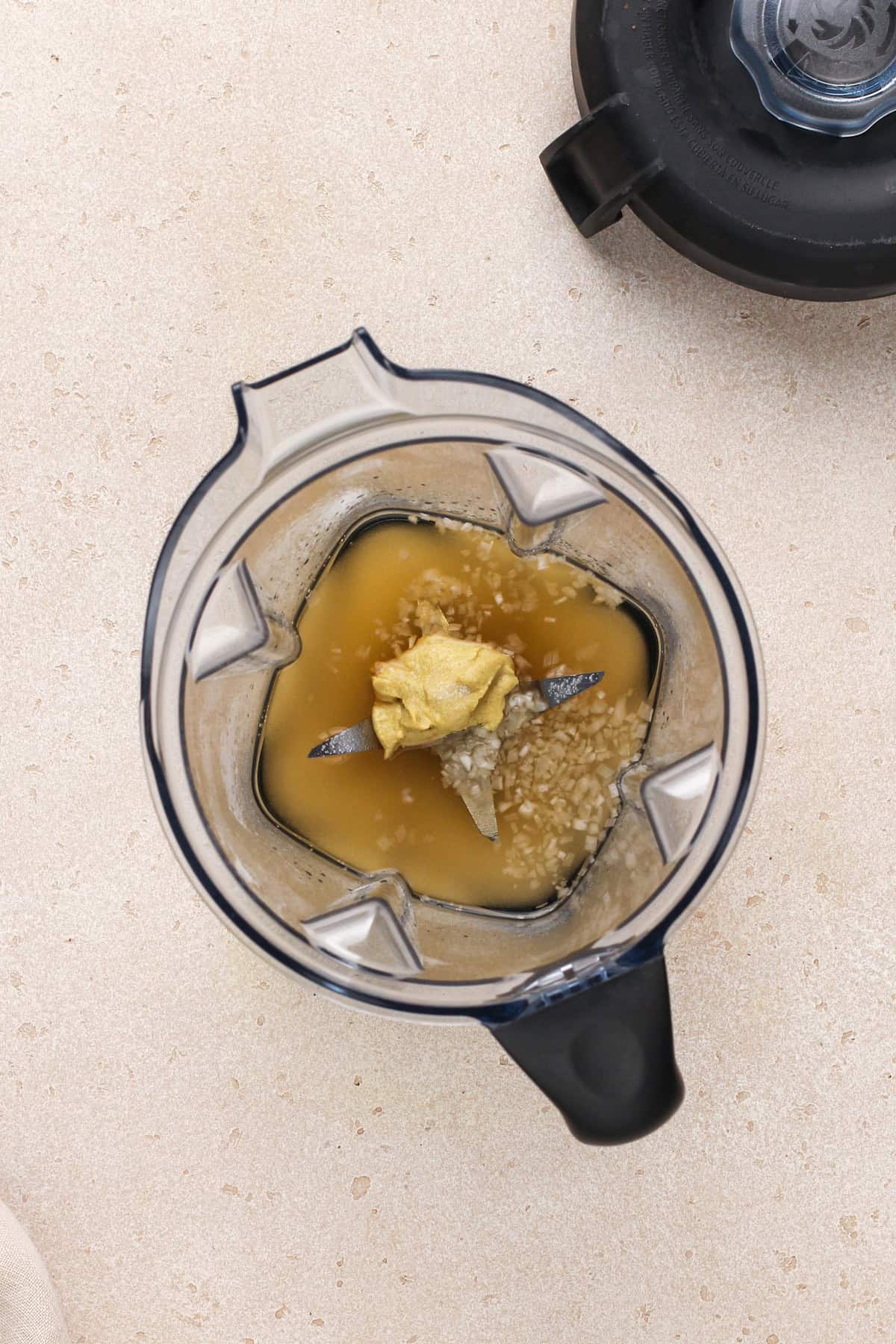 ingredients for poppy seed dressing in the bowl of a blender.