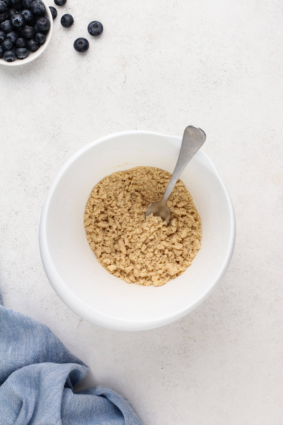 Streusel topping for muffins mixed in a white bowl.