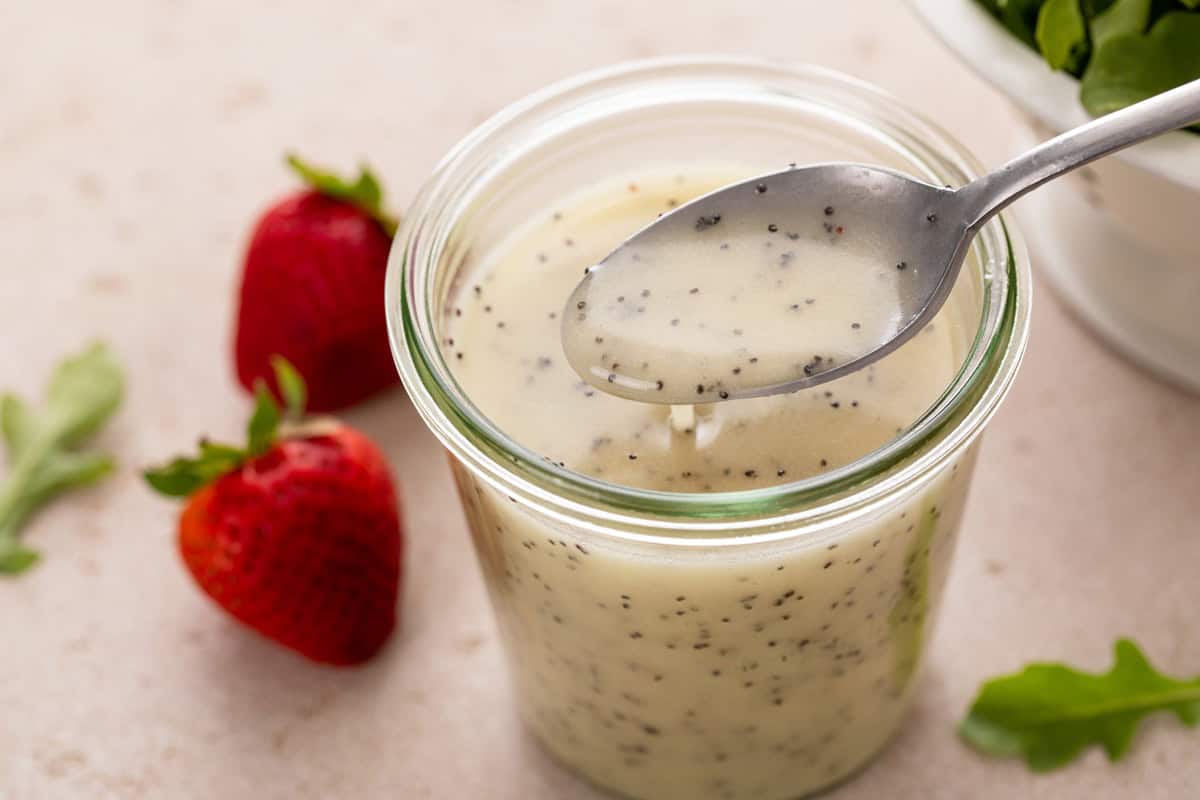 Spoon in a jar of poppy seed dressing.
