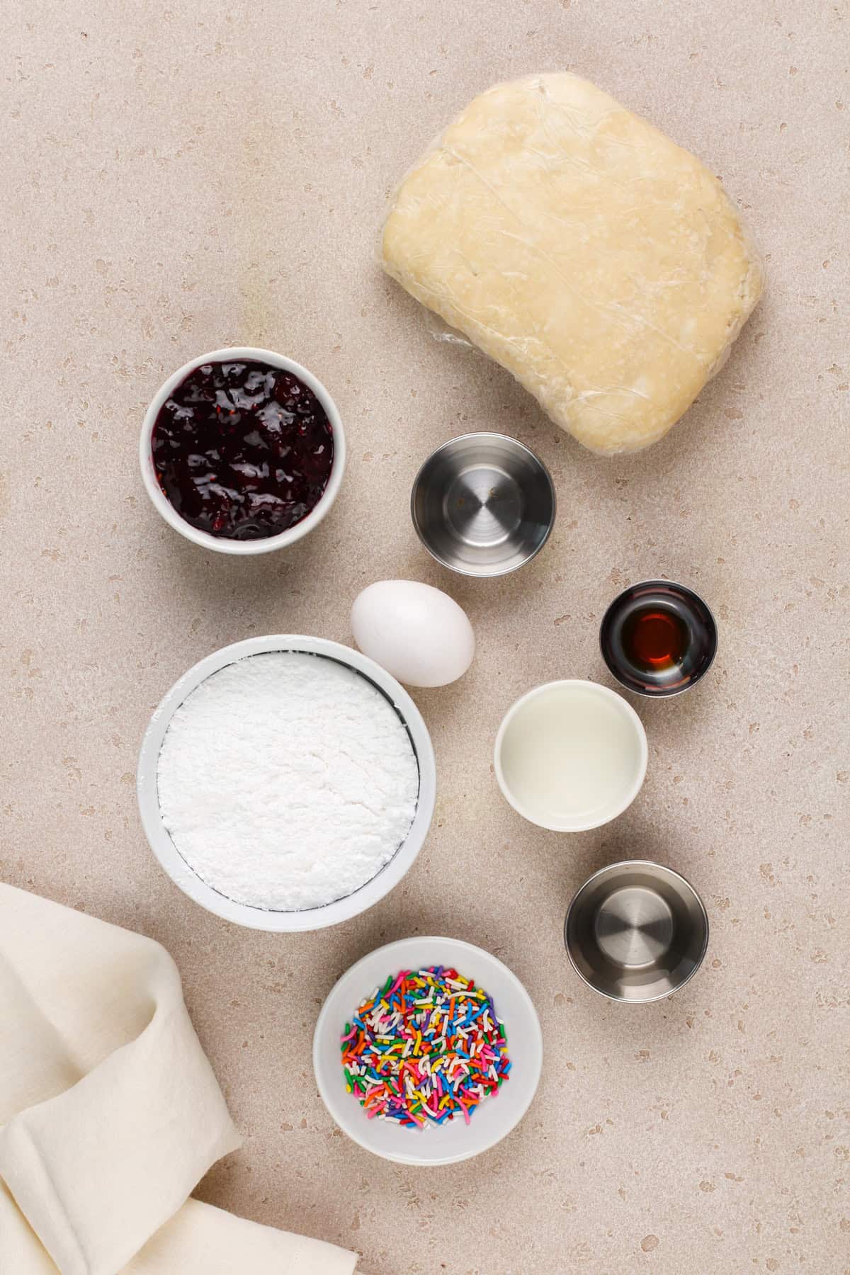 Ingredients for homemade pop tarts arranged on a beige countertop.