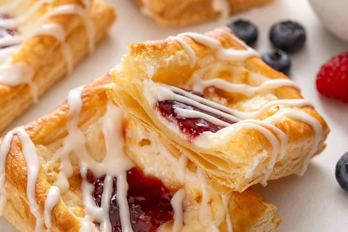 Halved puff pastry danish propped against a second danish.