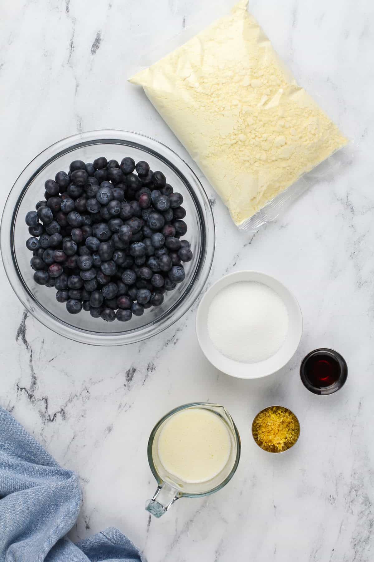 Blueberry dump cake ingredients arranged on a countertop.