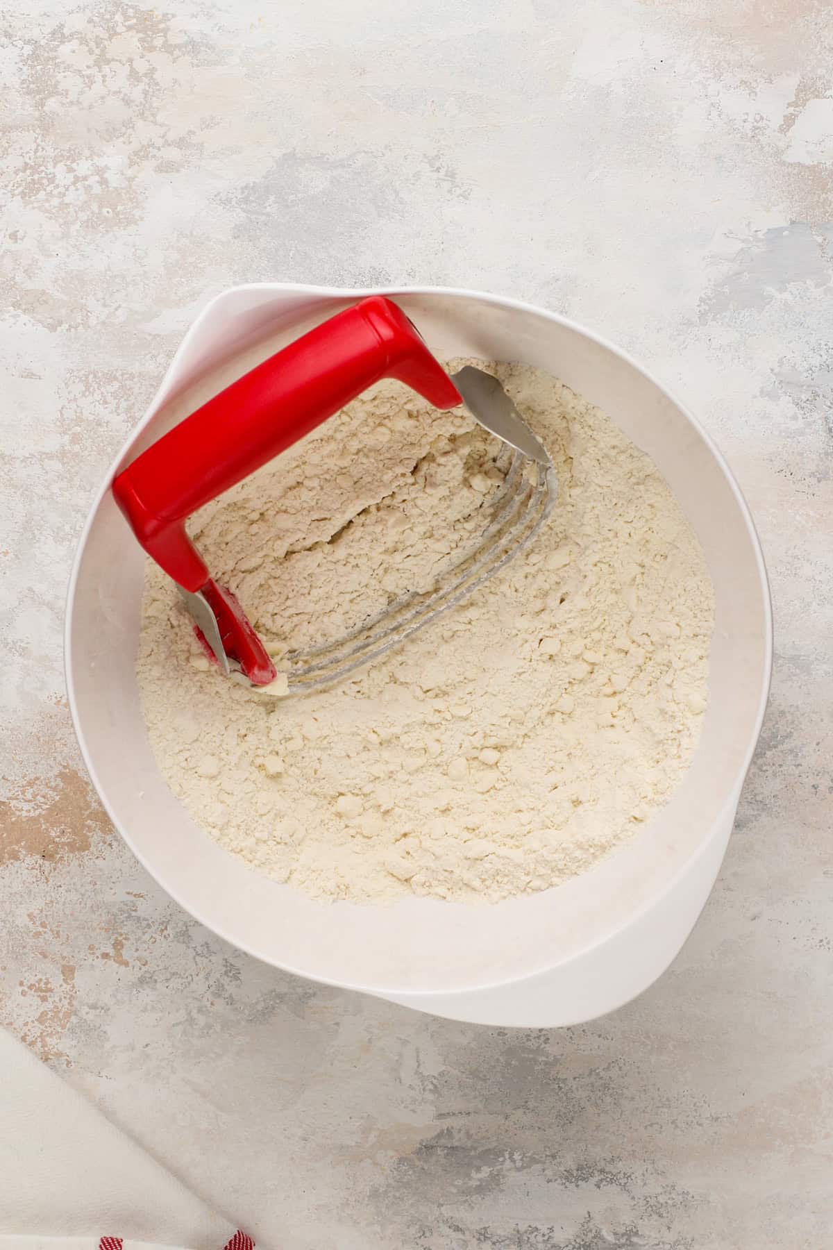 Butter cut into dry ingredients for biscuits.