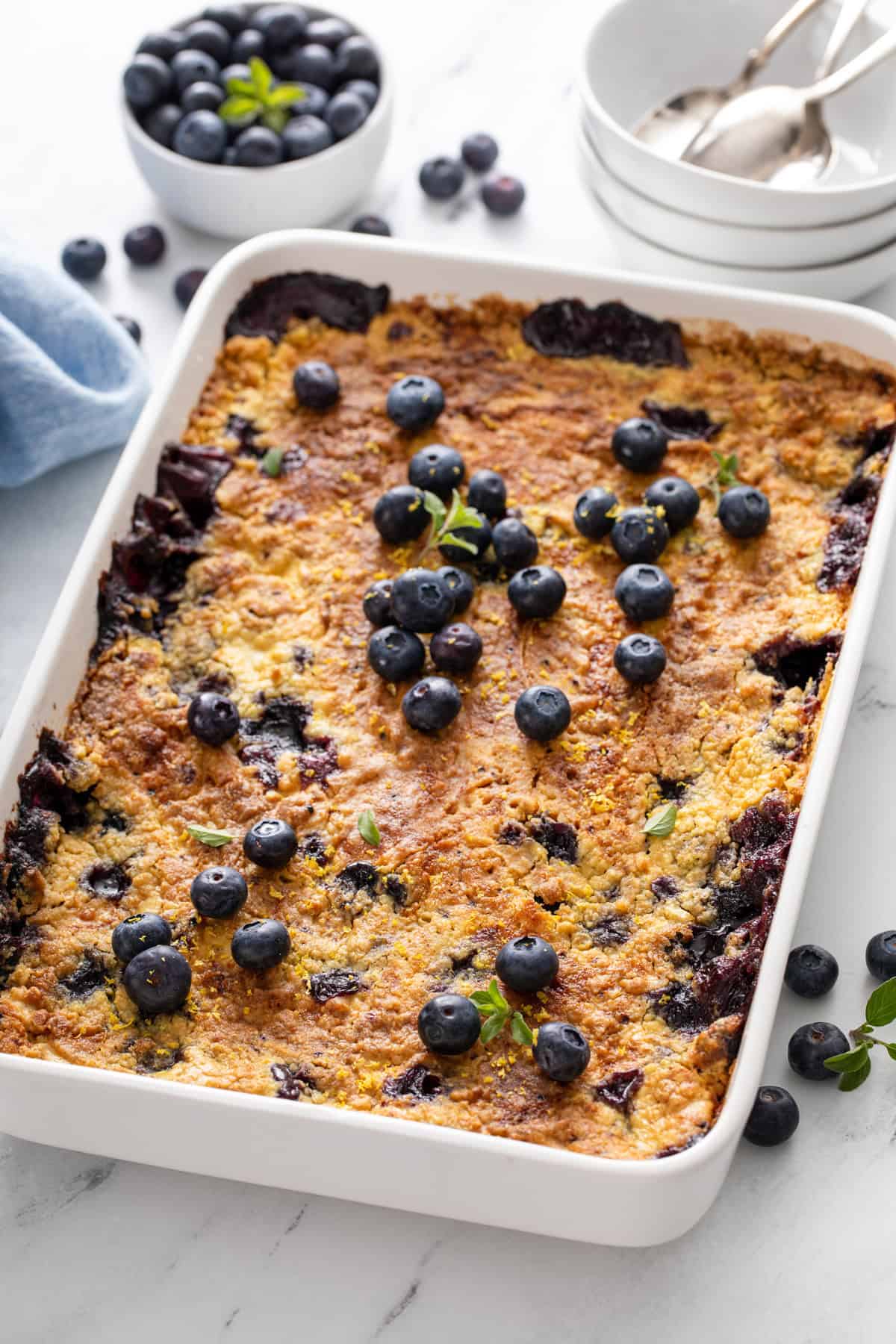White baking dish filled with blueberry dump cake.