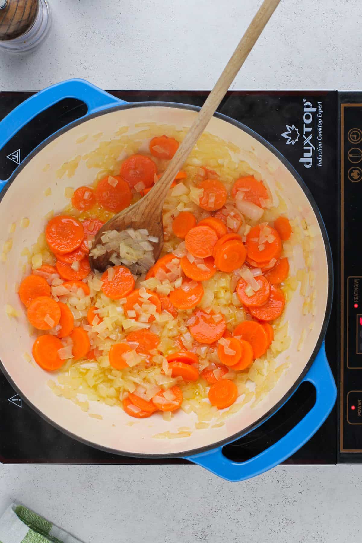 Sauteed onions and carrots in a dutch oven.