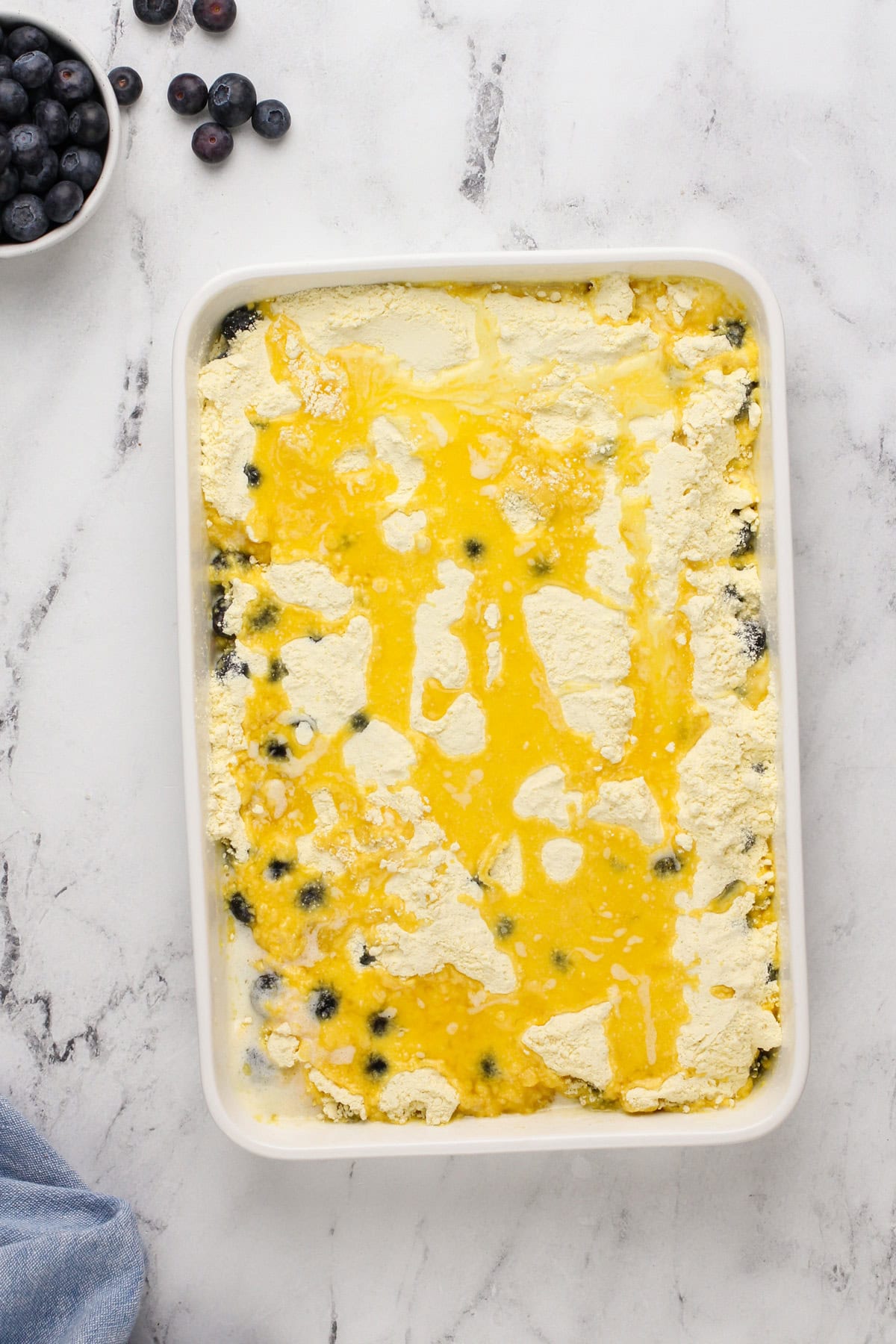 Assembled blueberry dump cake ready to go in the oven.