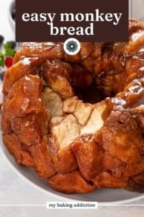 Several pieces taken from easy monkey bread on a white platter. Text overlay includes recipe name.