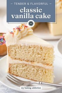 Close up of a slice of vanilla layer cake next to a fork on a white plate. Text overlay includes recipe name.