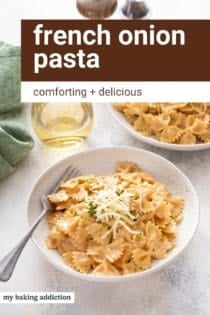 Two white pasta bowls filled with french onion pasta next to a glass of wine. Text overlay includes recipe name.