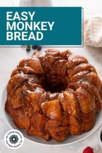 Cooled easy monkey bread on a white platter. Text overlay includes recipe name.