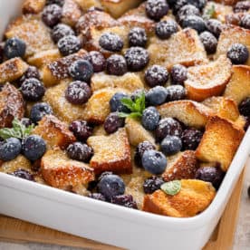 White baking dish filled with blueberry french toast casserole.