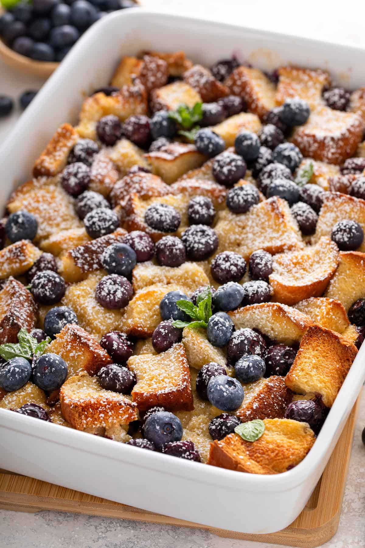 Blueberry french toast casserole dusted with powdered sugar.
