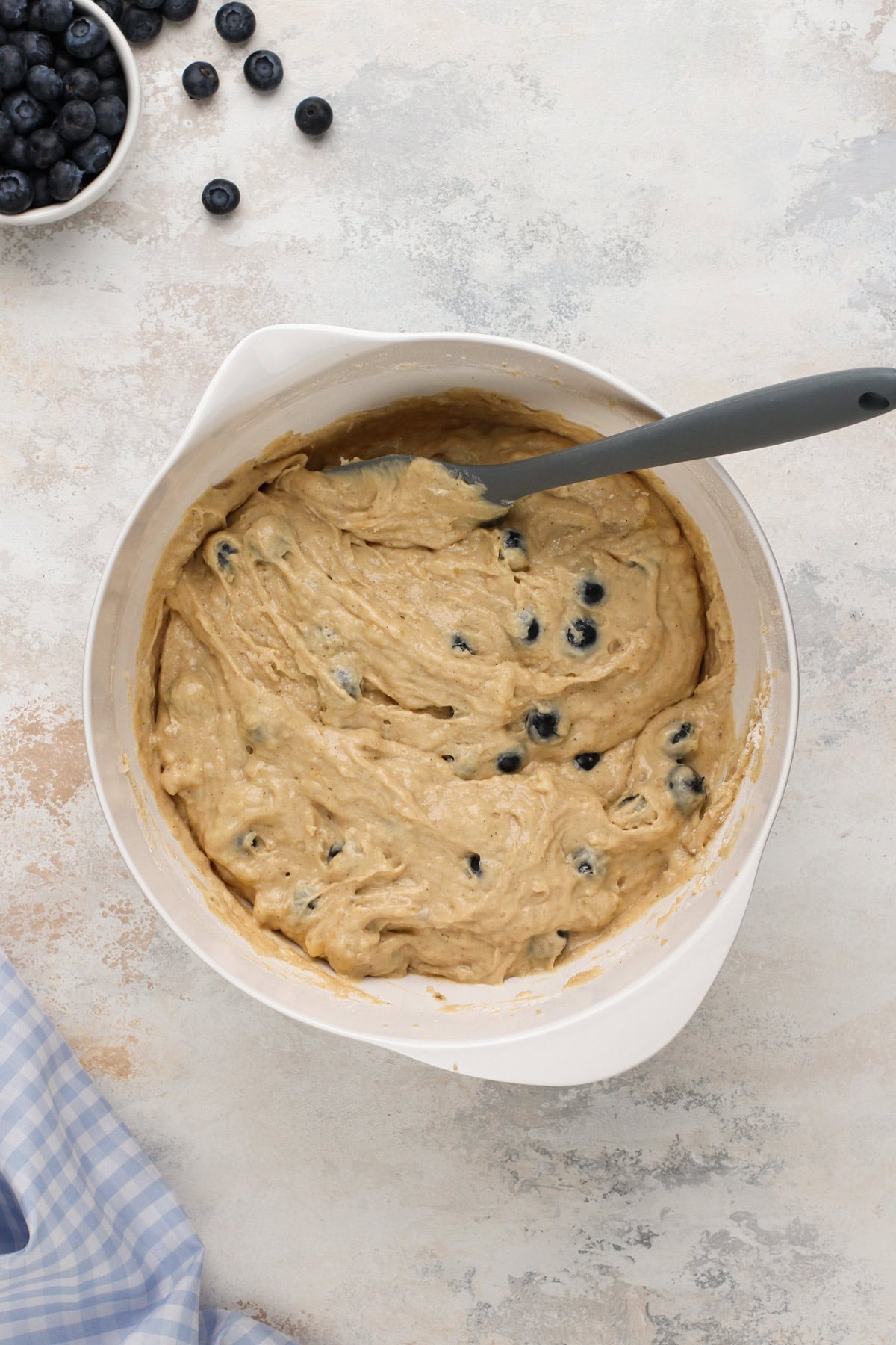 Blueberry banana bread batter mixed in a white bowl.